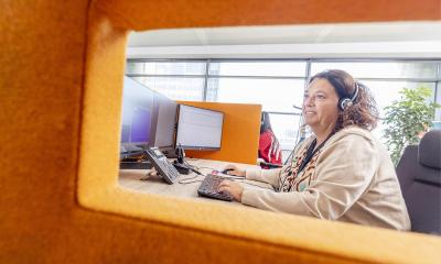 Vrouw neemt telefoon op in De Zorgcentrale